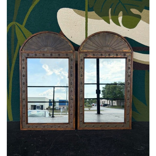 Unique pair of Sarreid mirrors that are hefty and well-made. Brass accents, fan tops, and bracketed to hang.