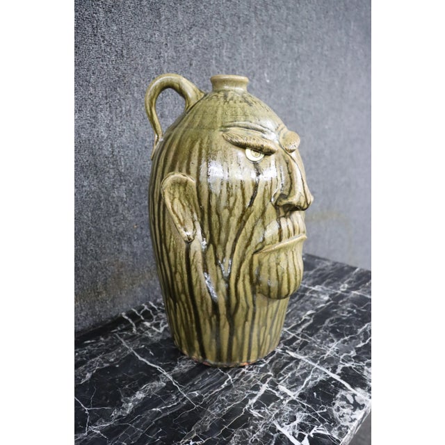 Hand made terra-cotta face jug.
