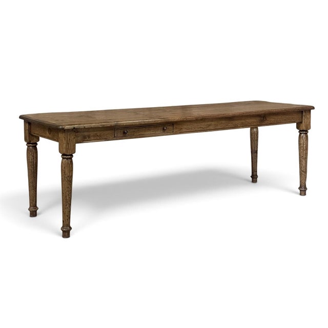 An antique English pine farm table carries the warmth of the English countryside, its original patina deepened by...