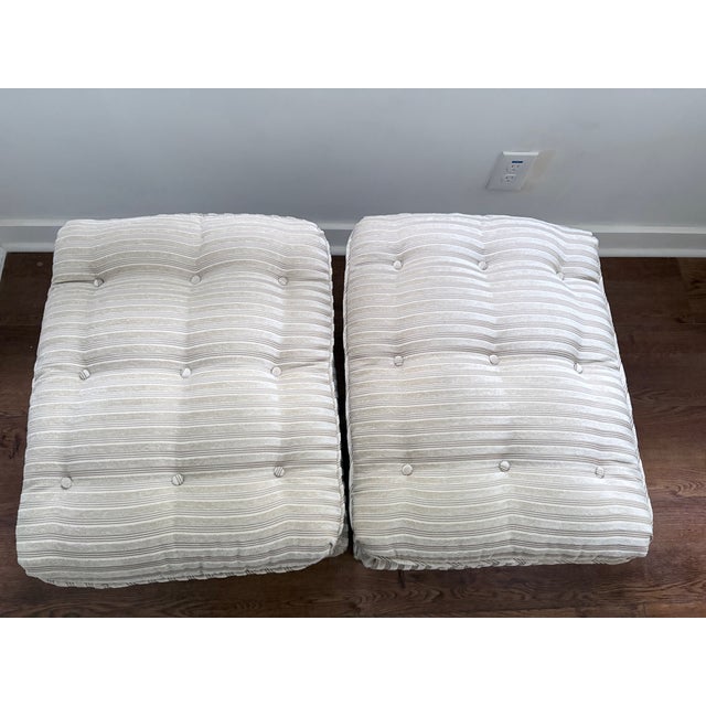 Pair of upholstered X leg benches. Upholstered in warm grey fabric. Tufted cushions are attached. Heavy and solid, in...