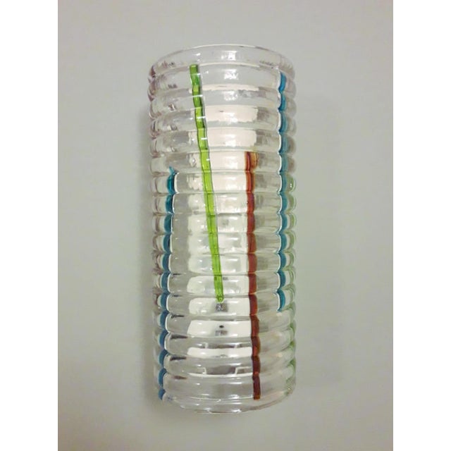 Vintage Italian wall lights with clear ribbed Murano glass shades decorated with multicolored stripes, mounted on white...