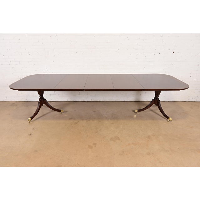 An exceptional Georgian or Regency style double pedestal extension dining table By Councill Furniture USA, Circa 1980s...