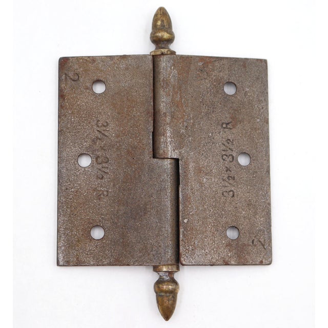 This right handed door hinge is made of cast iron with brass acorn tips, a lift off knuckle, and a template hole pattern....