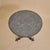A French iron and concrete guéridon side table dating to the 1940s. The circular concrete top has a subtly weathered...