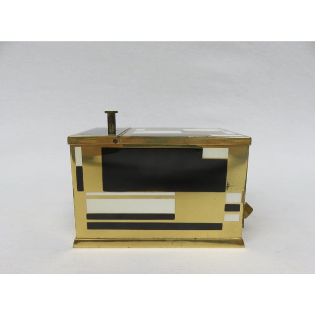 The cigarette dispenser was produced by Erhard & Söhne. It is made of brass, partially painted with enamel paint with a...