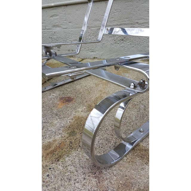 Here is a striking pair of heavy chrome steel high back cantilevered lounge chairs. These chairs resemble the designs of...