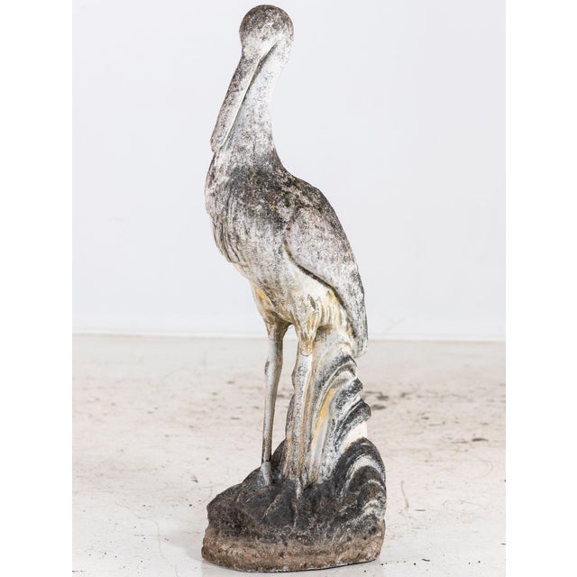 This French 1950s reconstituted stone heron or crane sculpture has an elegant, elongated form with fine detailing along...