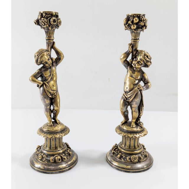 We are selling this great pair of French silvered bronze candlesticks. The two candlesticks take the form of cherubs or...