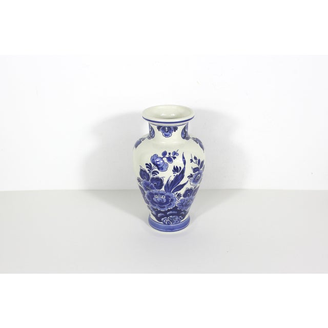 Vintage blue and white floral Delft pottery made in Holland. 8” tall 4.5” wide Marked on bottom: Delfts Holland Handwerk