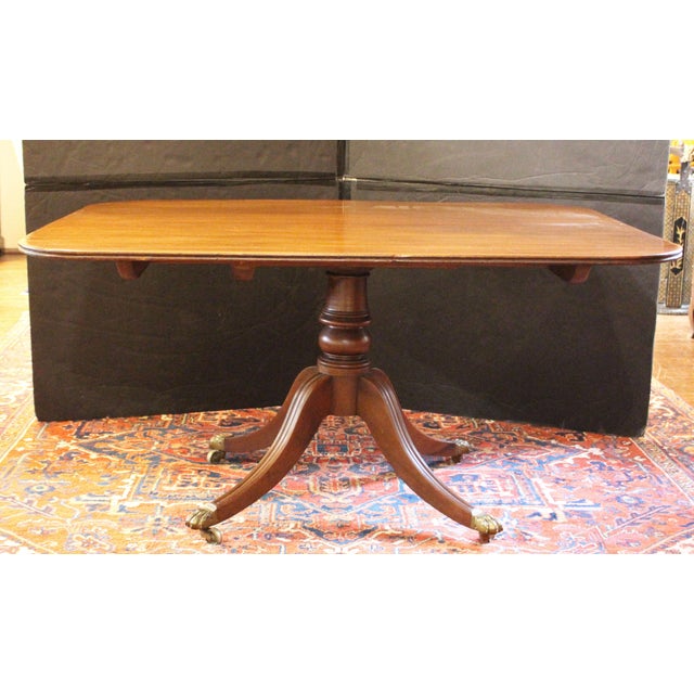 Circa 1800 George III tilt-top breakfast table, English. Mahogany . Raised on boldly molded legs below equally bold...