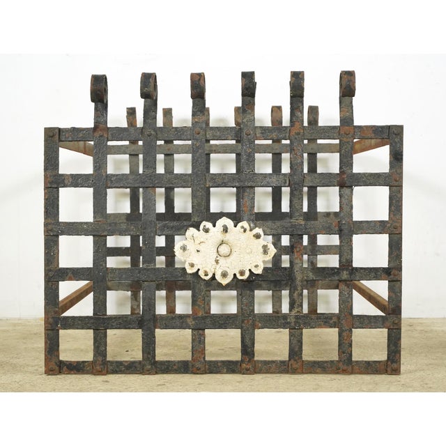Hand forged wrought iron box shaped unit with a black finish and an ornate embellishment. The original use is unknown. It...
