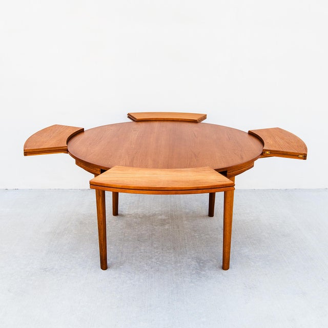 Dyrlund's iconic "Flip Flap" dining table features one of the most innovative expansion mechanisms in Danish Modern...