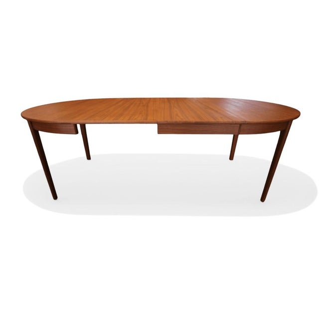 A very beautiful and stylish teak dining table with a lovely rich colour tone, manufactured by the Danish company C.J....