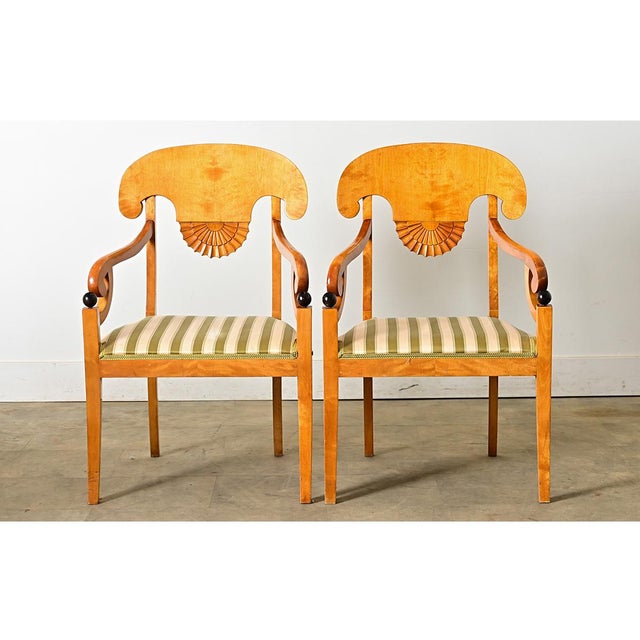 Danish, early 20th century pair of Biedermeier armchairs made during the reign of Christian X (1912-1947). The chair...
