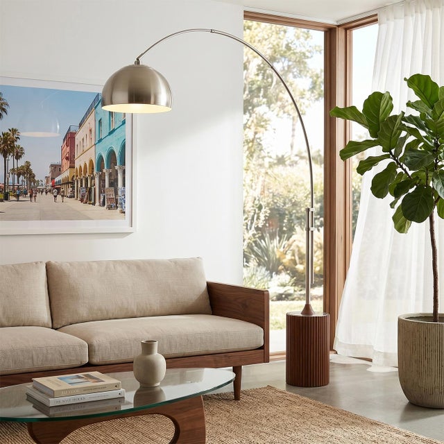 Featuring a dramatic blend of suspension and natural materials, the Tambo 92" Arc Lamp is a Mid-Century Modern masterpiece...