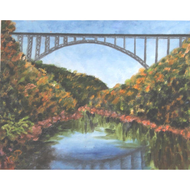 American Appalachian mountain landscape, and bridge, with lime green grass, pale blue sky and river sienna river rocks....