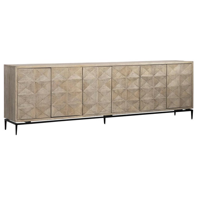 Long mango wood sideboard with light warm washed finish. This cabinet features a carved subtle diamond pattern on six...