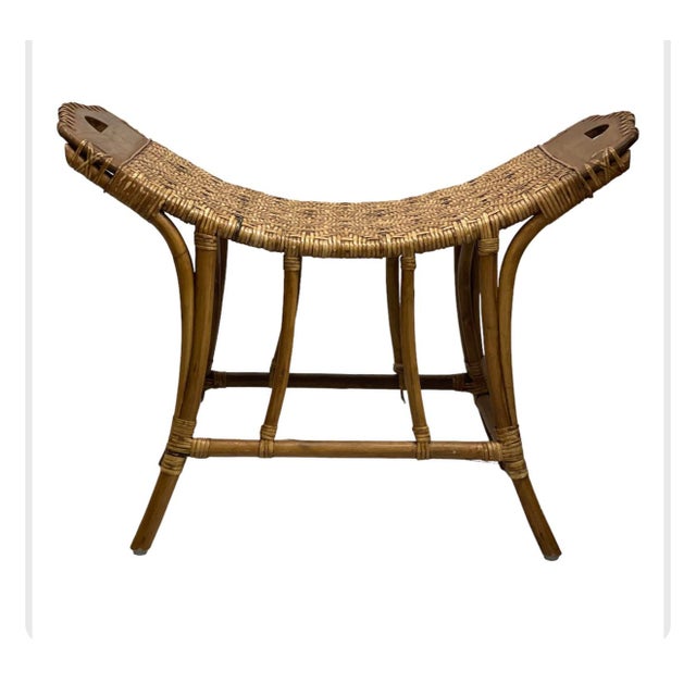 This vintage bench features a curved, woven wicker seat with a tight, herringbone pattern, supported by a bamboo frame....