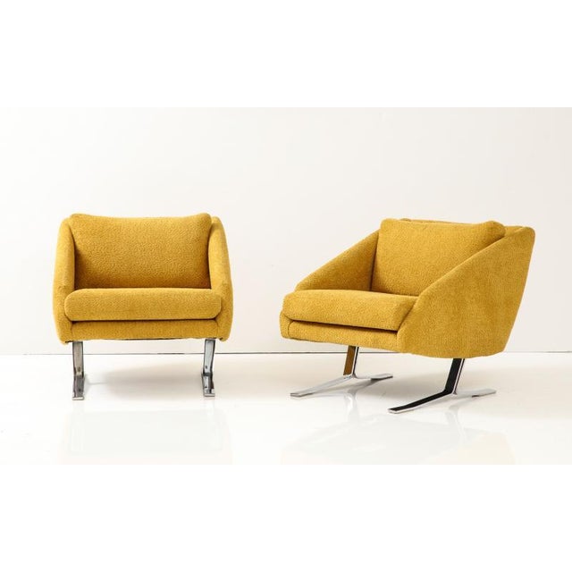 Pair of Mid Century Modern Lounge Chairs. Chrome plated steel bases. Sloped mod frame re-upholstered in plush gold. 1970's.