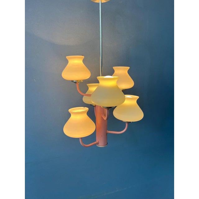 One-of-a-kind mid-century opaline milk glass chandelier featuring a distinctive pink metal frame and six elegant opaline...