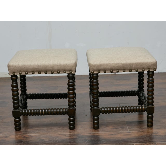 This pair of 19th-century English stools combines classic craftsmanship with updated upholstery, offering both character...