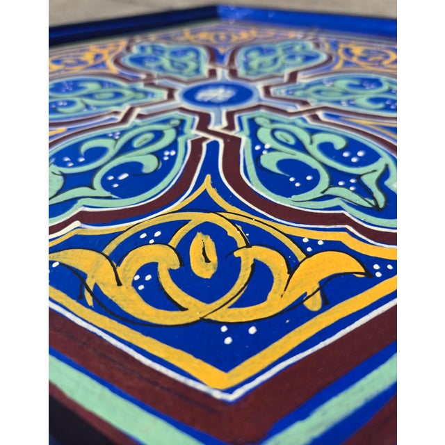 Striking Moroccan-style accent table or stool featuring a hexagonal silhouette and vibrant hand-painted details in rich...