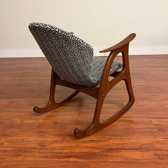 Vintage Danish teak rocking chair by Aage Christiansen for Erhardsen Andersen, made in Denmark circa 1961. This piece...