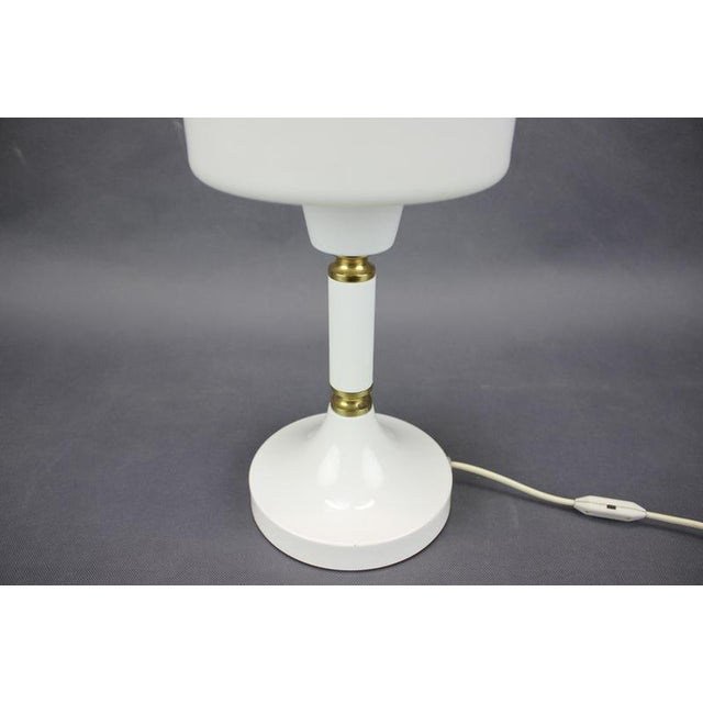 Elegant vintage table lamp manufactured by Drukov Brno in Czechoslovakia during the 1970s. The lamp features a refined...