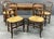 A beautiful set of four vintage French Provincial ladderback dining chairs featuring handwoven rush seats and elegant...