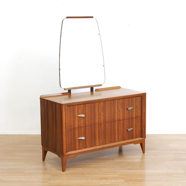 This mid-century vanity dresser was produced in England during the 1960s. A classy vintage bedroom storage piece with two...