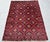Bring rich texture and sophisticated tribal craftsmanship to your living space with this striking hand-knotted wool area...
