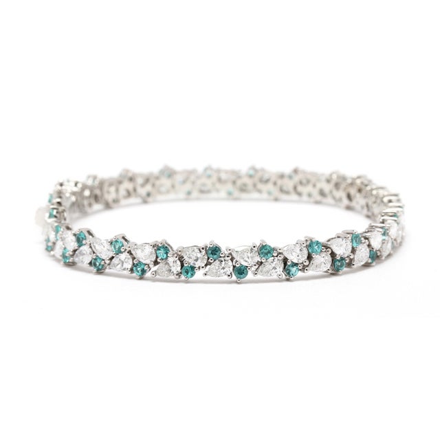 Stones: diamond pear 6.04ctw FG color/ VS2-SI1 clarity round brilliant cut 1.9ctw blue color/ SI1-2 clarity Length: 7.25...
