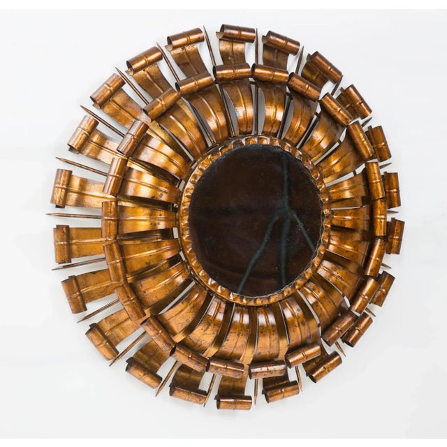 Vintage round sunburst mirror in gilt metal with a double border of stylized leaves in lovely original condition....