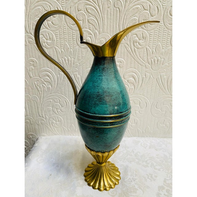 This stunning turquoise and brass pitcher is a true representation of mid-century modern design from Oppenheim, Israel....