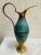 This stunning turquoise and brass pitcher is a true representation of mid-century modern design from Oppenheim, Israel....