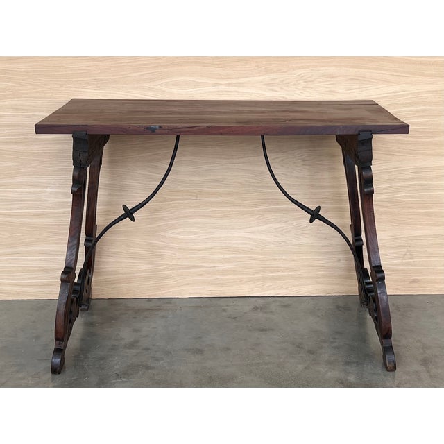 19th Spanish side table with cared Solomonic turned legs and iron stretcher. The top has a carved edges and a beautiful...