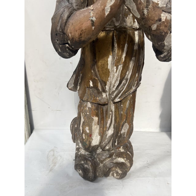 Pair of polychrome and gilded carved wooden adoring angels Two kneeling angels on a cloud Sold as is, with wear and some...