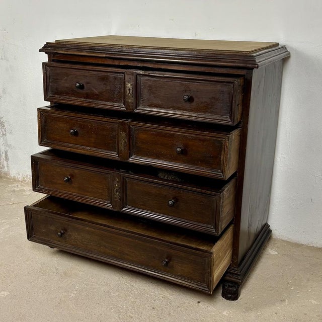 Elegant Spanish chest of drawers crafted in solid oak with strong architectural lines and a richly aged patina. The piece...