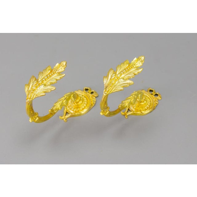 A pair of French Louis XIV-style gilt bronze curtain tiebacks or curtain holders. A beautiful pair of Louis XIV-style...
