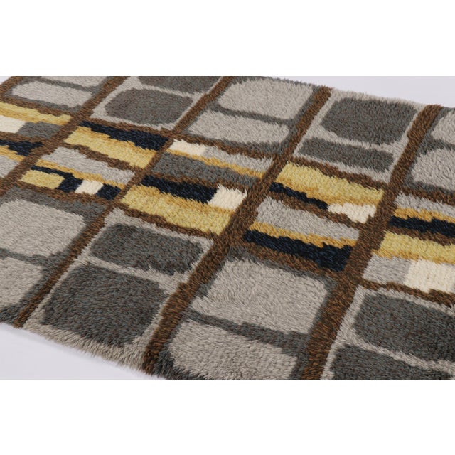 Hand-knotted in lush, high-pile wool in Sweden circa 1960-1970, this 5x6 vintage Swedish Rya rug is a bold new addition to...