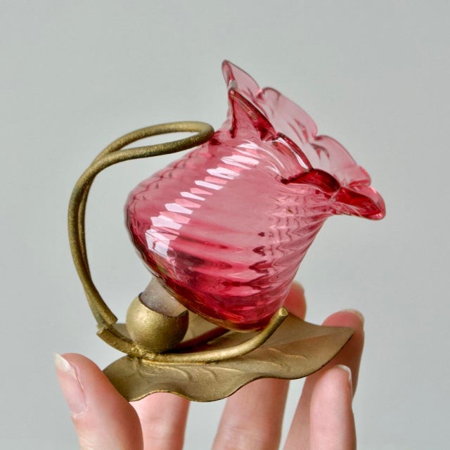 Beautiful pair of Victorian English glass salt cellars by Thomas Webb, featuring rich cranberry glass with delicate floral...