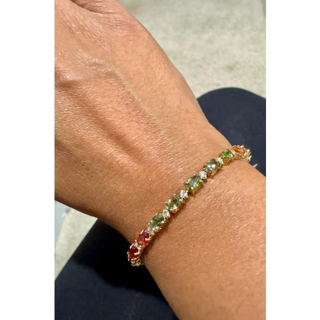 Beautifully designed 8.83 Carat Multi-Color Sapphire and Diamond Yellow Gold Tennis Bracelet. This gorgeous piece has 25...