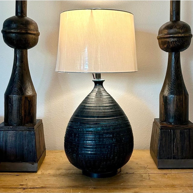Generous in shape and color. Blue drip glaze. I recommend a larger shade with this. It is 29” tall to the top of this...