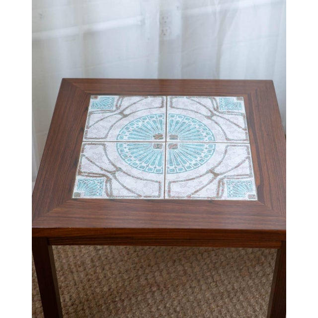 These vintage Danish rosewood side tables feature beautiful ceramic tile inlays—both decorative and practical. The rich...