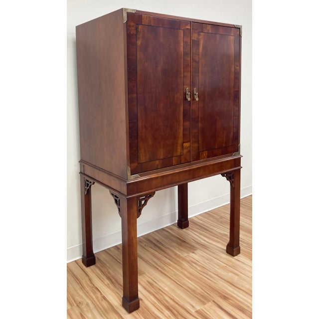 Beautiful vintage Chinoiserie style media cabinet featuring rich natural wood with inlays to doors and etched brass...