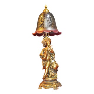 Edwardian Gilt Brass Cherub Musician Lamp with Cranberry Glass, 1910s For Sale