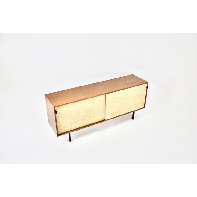 Sideboard with two canvas-lined sliding doors, leather handles and metal feet. It features height-adjustable shelves. Wear...