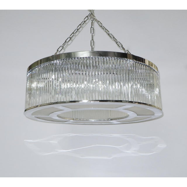 Italian art deco style drum chandelier with double layers of thin clear Murano glass rods mounted on chrome finish...