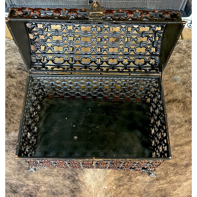 Striking vintage metal chest featuring an intricate pierced lattice design and dramatic domed lid. The repeating...