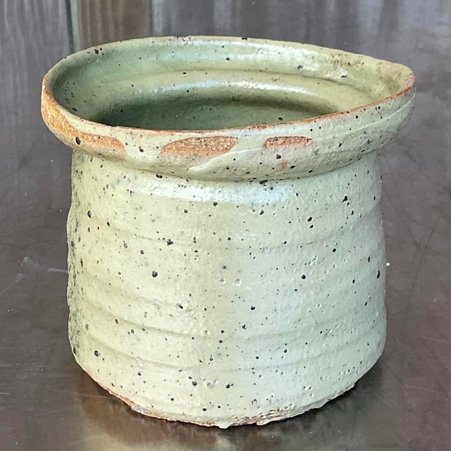 The Vintage Boho Studio Pottery Vase offers a beautifully unique, handcrafted design with its organic, raw aesthetic and...